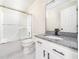 Modern bathroom with granite counters, sleek fixtures, and a glass-enclosed shower at 440 Hickory Glen Sw Ln, Atlanta, GA 30311