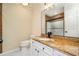 Bathroom featuring granite countertops, white cabinets, a modern faucet, a large mirror, and a shower with glass doors at 440 Hickory Glen Sw Ln, Atlanta, GA 30311