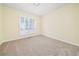 Comfortable bedroom featuring plush carpeting and a window with white shutters, providing a comfortable and private space at 440 Hickory Glen Sw Ln, Atlanta, GA 30311