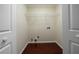 Small, unfinished laundry room with hardwood floors and white walls at 440 Hickory Glen Sw Ln, Atlanta, GA 30311