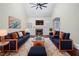 Sun-filled living room with a fireplace, stylish sofas, a plush rug, and modern decor under a ceiling fan at 440 Hickory Glen Sw Ln, Atlanta, GA 30311