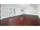 Bright room featuring hardwood floors, white walls and baseboards, and french doors with white shutters at 440 Hickory Glen Sw Ln, Atlanta, GA 30311