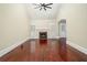 Bright living room with high ceilings, hardwood floors, a cozy fireplace, and large windows with shutter accents at 440 Hickory Glen Sw Ln, Atlanta, GA 30311