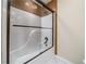 Close-up of the shower, featuring a shower head, glass sliding doors, and granite surrounding the shower at 440 Hickory Glen Sw Ln, Atlanta, GA 30311