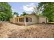 The backyard shows the exterior with a sunroom and a stone ground covering at 6292 Field Glen Rd, Stone Mountain, GA 30087