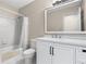 Clean bathroom features a shower-tub combo with tile surround and a white vanity with modern fixtures at 6292 Field Glen Rd, Stone Mountain, GA 30087