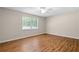 Bright bedroom with wood-look floors and a large window offering natural light and views at 6292 Field Glen Rd, Stone Mountain, GA 30087