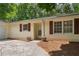 Cozy home featuring brown shutters, a light-colored exterior, and well-maintained landscaping around the front entrance at 6292 Field Glen Rd, Stone Mountain, GA 30087