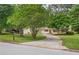 Charming home featuring a well-maintained front yard, mature trees, and a driveway at 6292 Field Glen Rd, Stone Mountain, GA 30087