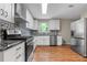 Modern kitchen featuring stainless steel appliances, new cabinets, and attractive counters at 6292 Field Glen Rd, Stone Mountain, GA 30087