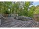 Large backyard deck with an above-ground pool, a ladder and wooden fence at 2675 Paul Thomas Dr, Dacula, GA 30019
