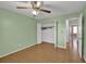 Bedroom with hardwood floors, ceiling fan, closet, and doorway to the bathroom at 2675 Paul Thomas Dr, Dacula, GA 30019