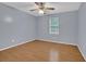 Bedroom features stylish blue walls, hardwood floors, ceiling fan and a window at 2675 Paul Thomas Dr, Dacula, GA 30019