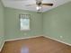 Cozy bedroom features hardwood floors, ceiling fan and natural light from the window at 2675 Paul Thomas Dr, Dacula, GA 30019