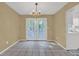 Bright dining room with tile floors, a chandelier, and access to the kitchen and outdoor patio at 2675 Paul Thomas Dr, Dacula, GA 30019