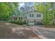 Charming two-story home featuring a double garage, wood siding, and an inviting front yard in a serene setting at 2675 Paul Thomas Dr, Dacula, GA 30019