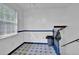Hallway with a window, blue trim, and access to an upper level via staircase at 2675 Paul Thomas Dr, Dacula, GA 30019