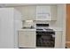 Kitchen featuring appliances and cabinets with black countertops at 2675 Paul Thomas Dr, Dacula, GA 30019