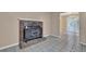 Living room featuring brick fireplace, neutral walls, and tile floors leading to a dining area at 2675 Paul Thomas Dr, Dacula, GA 30019