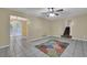 Open living room with tile floors, access to stairs, and adjoining space with French doors at 2675 Paul Thomas Dr, Dacula, GA 30019