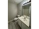 Bright bathroom featuring a tiled floor, spacious vanity, and a framed mirror at 3063 Grace Ct, Lawrenceville, GA 30043
