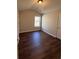 Cozy bedroom featuring hardwood floors and a window providing ample natural light at 3063 Grace Ct, Lawrenceville, GA 30043