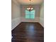 Elegant dining room with hardwood floors, wainscoting, and chandelier lighting at 3063 Grace Ct, Lawrenceville, GA 30043
