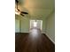 Well-lit living area with hardwood floors and a ceiling fan at 3063 Grace Ct, Lawrenceville, GA 30043