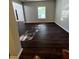 Open living area with hardwood floors and abundant natural light from a large window at 3063 Grace Ct, Lawrenceville, GA 30043