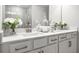 Bright bathroom featuring double vanity with white cabinets, quartz countertop, and decorative elements at 3078 Hudson Glen Way, Dacula, GA 30019