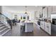 Modern kitchen with white cabinets, stainless steel appliances, an island with seating, and an adjacent dining area at 3078 Hudson Glen Way, Dacula, GA 30019