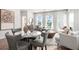Spacious living room with dining area, showcasing stylish furniture, decor, and ample natural light at 3078 Hudson Glen Way, Dacula, GA 30019