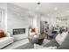 Open floor plan with fireplace, connected kitchen, dining area, and living room with stylish furniture at 3078 Hudson Glen Way, Dacula, GA 30019