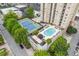 Aerial view showcasing the tennis court and pool amenities within a lush, urban complex at 325 E Paces Ferry Ne Rd # 602, Atlanta, GA 30305