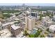 An aerial view showcasing a building complex with a pool, tennis court, and surrounding city skyline at 325 E Paces Ferry Ne Rd # 602, Atlanta, GA 30305