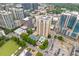 Panoramic aerial shot featuring a swimming pool and tennis court nestled among high-rise buildings and city streets at 325 E Paces Ferry Ne Rd # 602, Atlanta, GA 30305