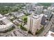 An aerial view showcases a modern building complex with a private pool, tennis court, and ample parking spaces at 325 E Paces Ferry Ne Rd # 602, Atlanta, GA 30305