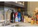 Close-up of a wet bar featuring granite countertops, decorative bottles, and a modern faucet at 325 E Paces Ferry Ne Rd # 602, Atlanta, GA 30305