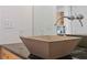 Close-up of a square vessel sink in a modern bathroom with granite countertops and custom faucet at 325 E Paces Ferry Ne Rd # 602, Atlanta, GA 30305