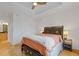 Spacious bedroom with a tray ceiling, fan, and wood floors, features a queen-sized bed and nightstand at 325 E Paces Ferry Ne Rd # 602, Atlanta, GA 30305