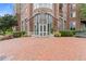 Beautiful brick building entrance with manicured landscaping and elegant glass entryway at 325 E Paces Ferry Ne Rd # 602, Atlanta, GA 30305