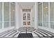The building entryway has white pillars and white and black tile at 325 E Paces Ferry Ne Rd # 602, Atlanta, GA 30305
