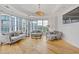 Bright living room with hardwood floors, large windows offering city views, and stylish furnishings at 325 E Paces Ferry Ne Rd # 602, Atlanta, GA 30305