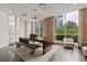 Bright lobby area with large table, wood bench, and comfortable seating, illuminated by natural light from expansive windows at 325 E Paces Ferry Ne Rd # 602, Atlanta, GA 30305