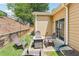 A backyard featuring a patio with a fire pit and seating, set in a lawn with garden beds and mature landscaping at 409 Norton Xing, Woodstock, GA 30188