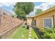 A cozy backyard featuring a small lawn, retaining wall, string lights, and a patio with a fire pit and chairs at 409 Norton Xing, Woodstock, GA 30188