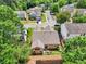 Aerial shot showing a backyard with patio furniture and a view of the fenced yard and surrounding homes at 409 Norton Xing, Woodstock, GA 30188