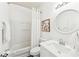 Bright bathroom featuring a shower-tub combo with white tile and a white vanity at 409 Norton Xing, Woodstock, GA 30188