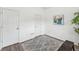 Neutral bedroom with a grey rug, hardwood floors, white walls, and vibrant artwork at 409 Norton Xing, Woodstock, GA 30188