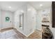 Inviting entryway with wood flooring, a decorative mirror, and a view of the bedroom at 409 Norton Xing, Woodstock, GA 30188